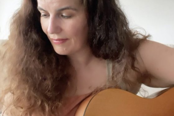 Cassandra playing guitar